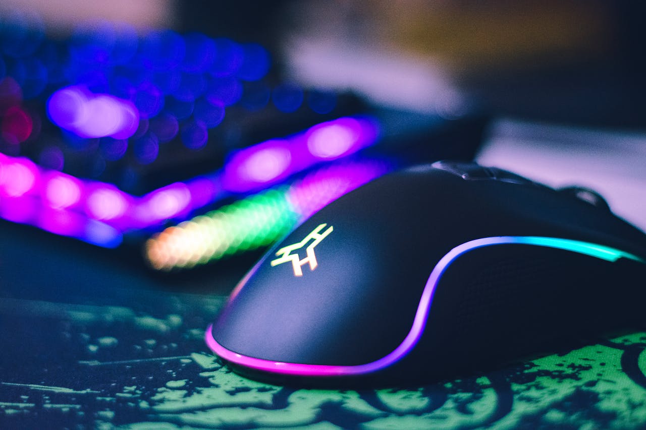 Services-02 A close-up of a colorful gaming mouse and illuminated RGB keyboard, perfect for tech setups.