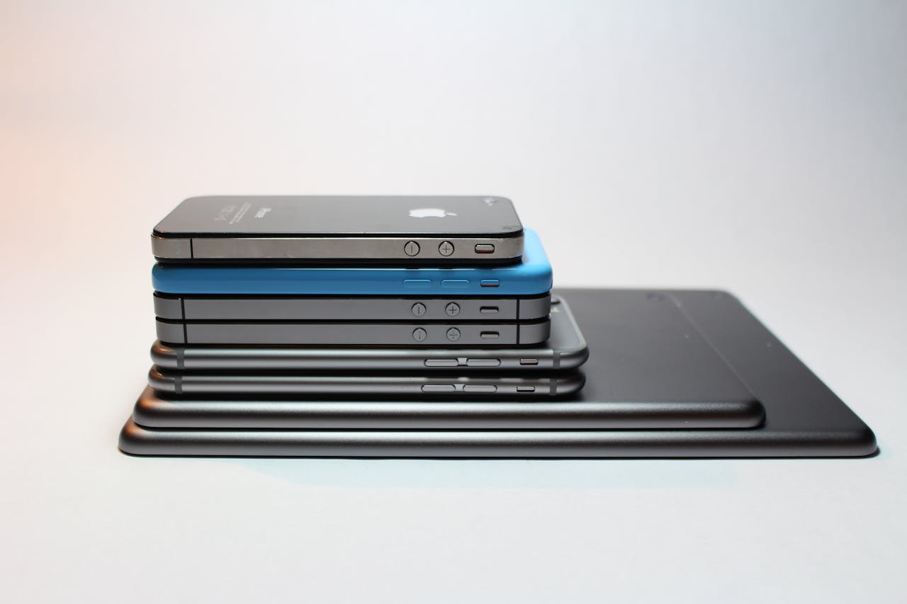 Services-03 Stacked modern smartphones and tablets showcasing sleek design. Perfect tech background.